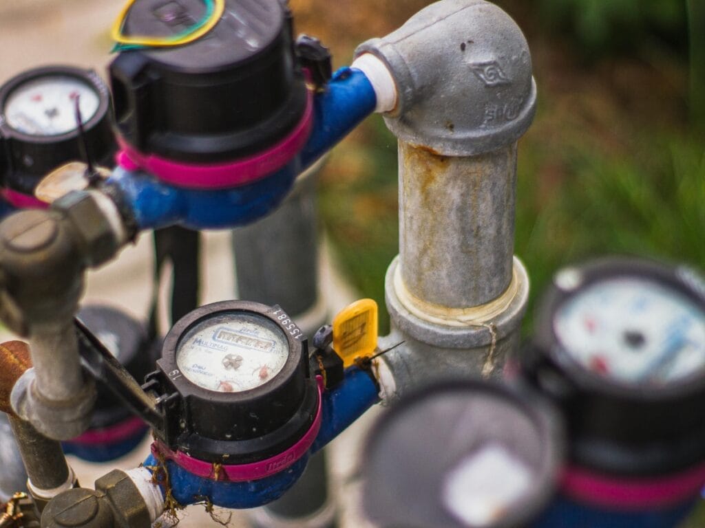 Water pressure gauge and plumbing valves, illustrating low water pressure diagnostics and solutions for residential plumbing issues.